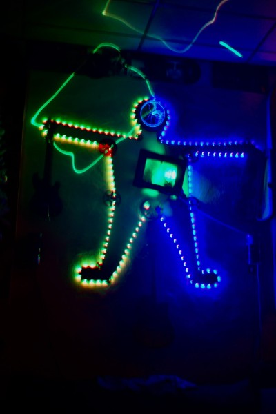 Colorful neon light figure installation glowing in blue and green